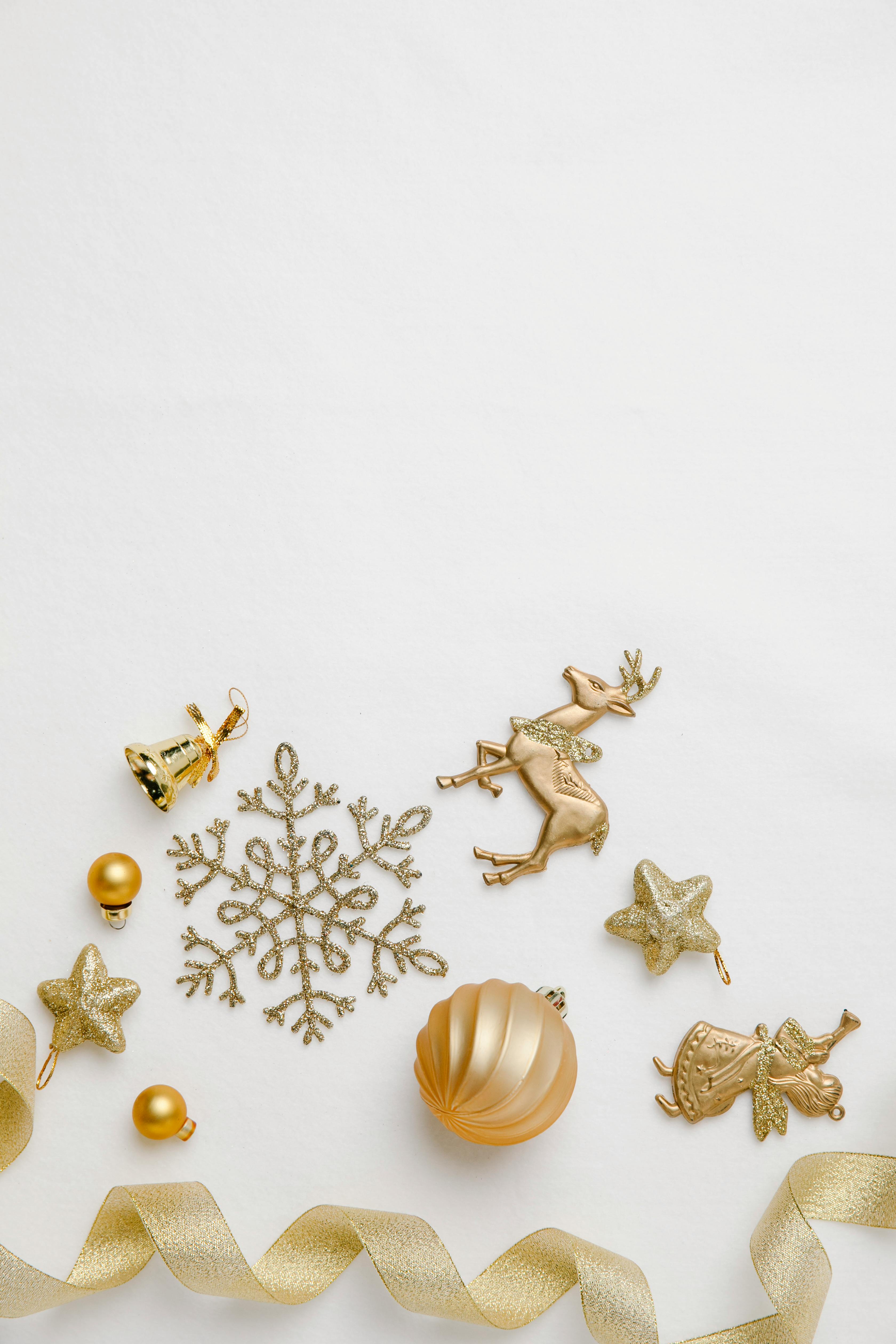 assorted golden christmas decor on white background