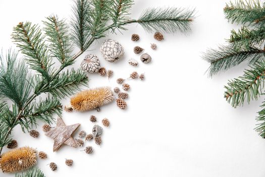 Overhead view of spruce tree twigs with different dry cones and star shaped decor