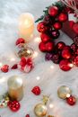 Flaming candle near colorful baubles during New Year holiday