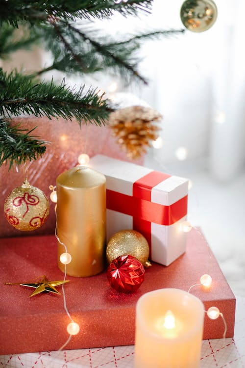Burning candles and gift boxes during Christmas holiday