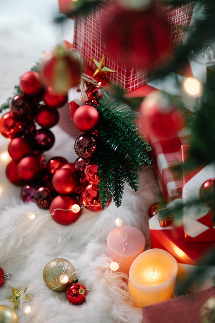 Decorated Christmas Tree And Candles On Fluffy Fabric