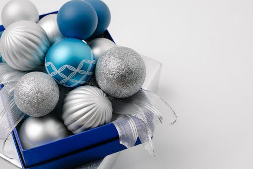 Festive sparkling silver and blue baubles in box