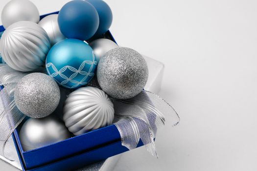 Festive sparkling silver and blue baubles in box