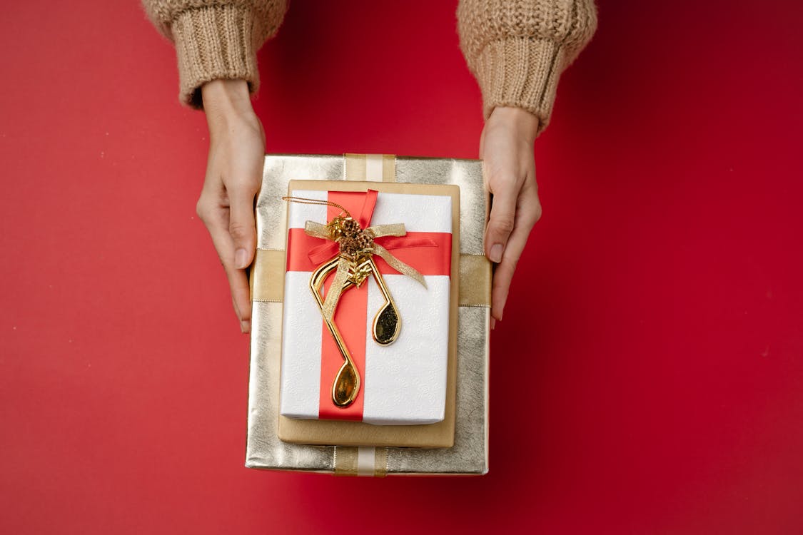 Free Crop woman with wrapped boxes Stock Photo