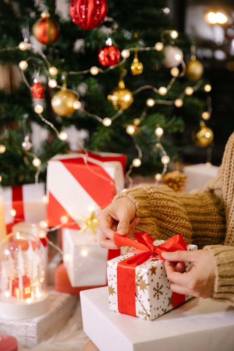 Woman Packaging Christmas Present In Box