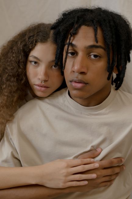 A loving interracial couple embracing, showcasing affection and connection in a close-up portrait.