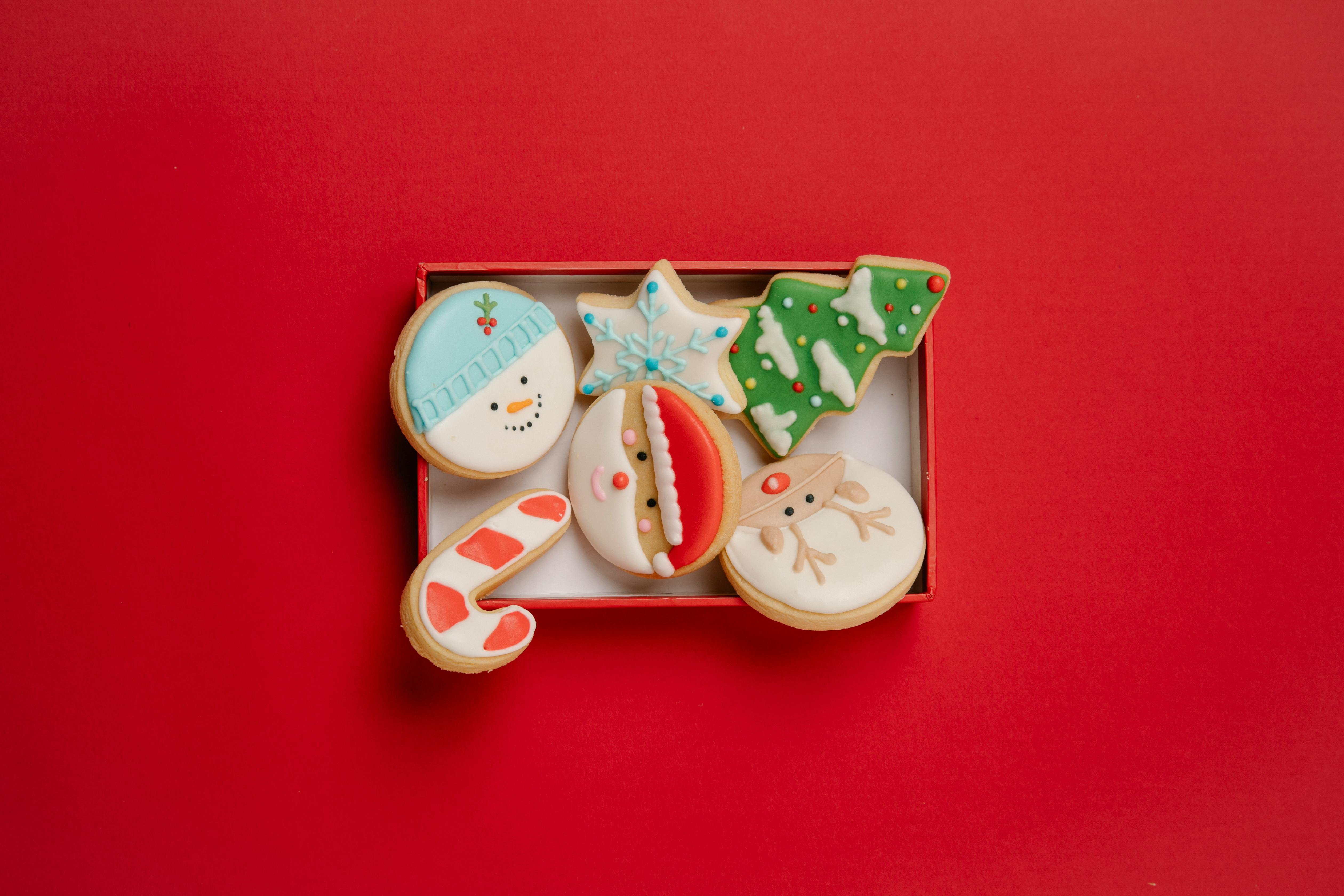 box with festive christmas biscuits topped with icing