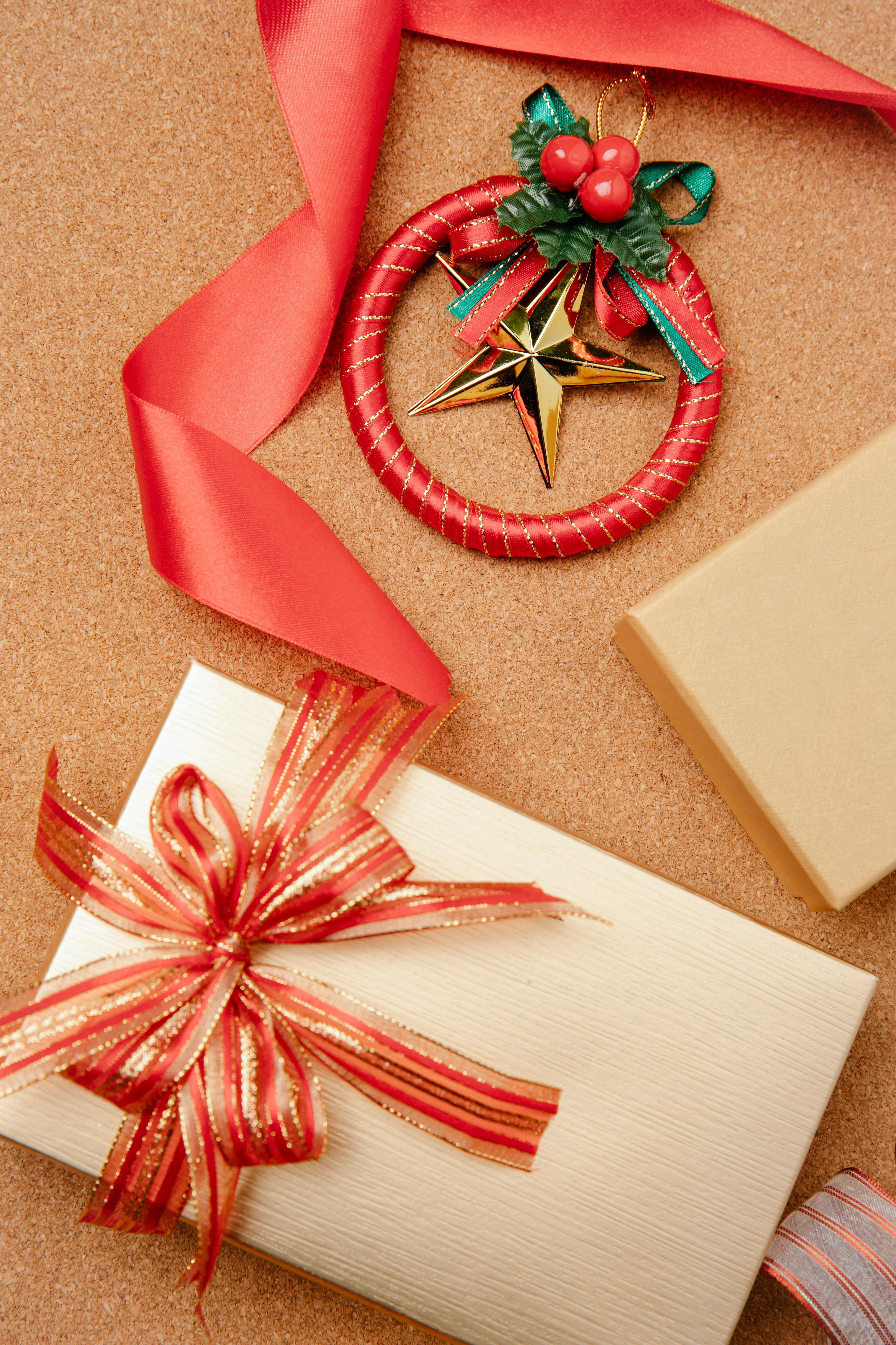 christmas gift box with red ribbon on table