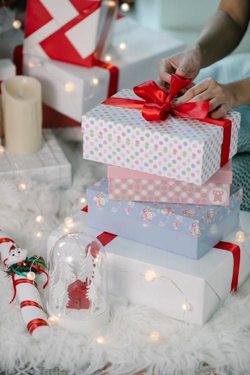 Woman preparing for Christmas and decorating gift box