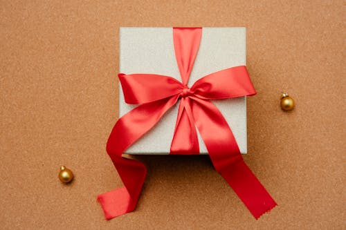 Gift box with ribbon on table