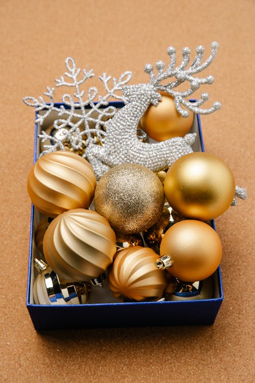 Box with shiny baubles and festive ornaments