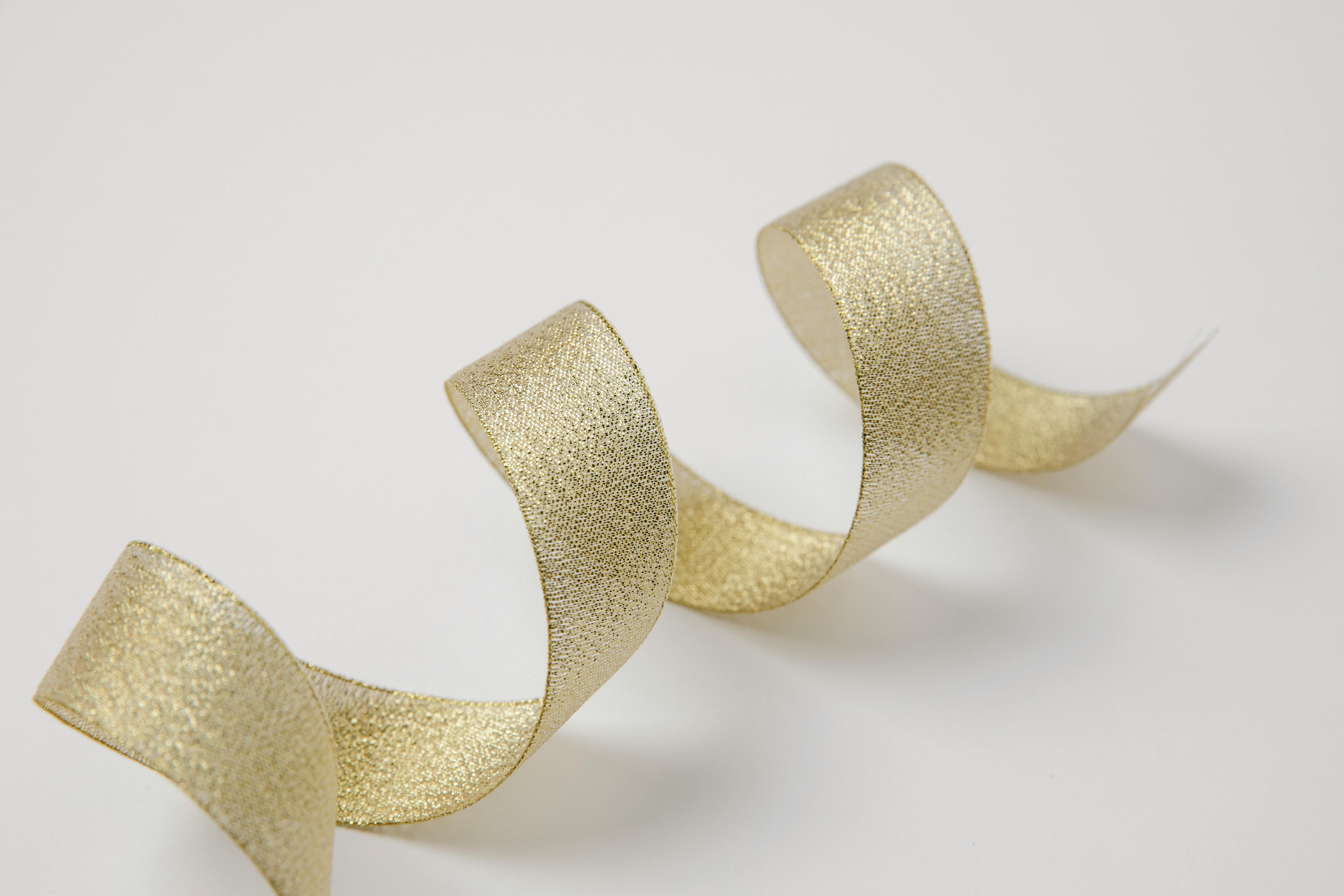 wavy golden silky ribbon on table