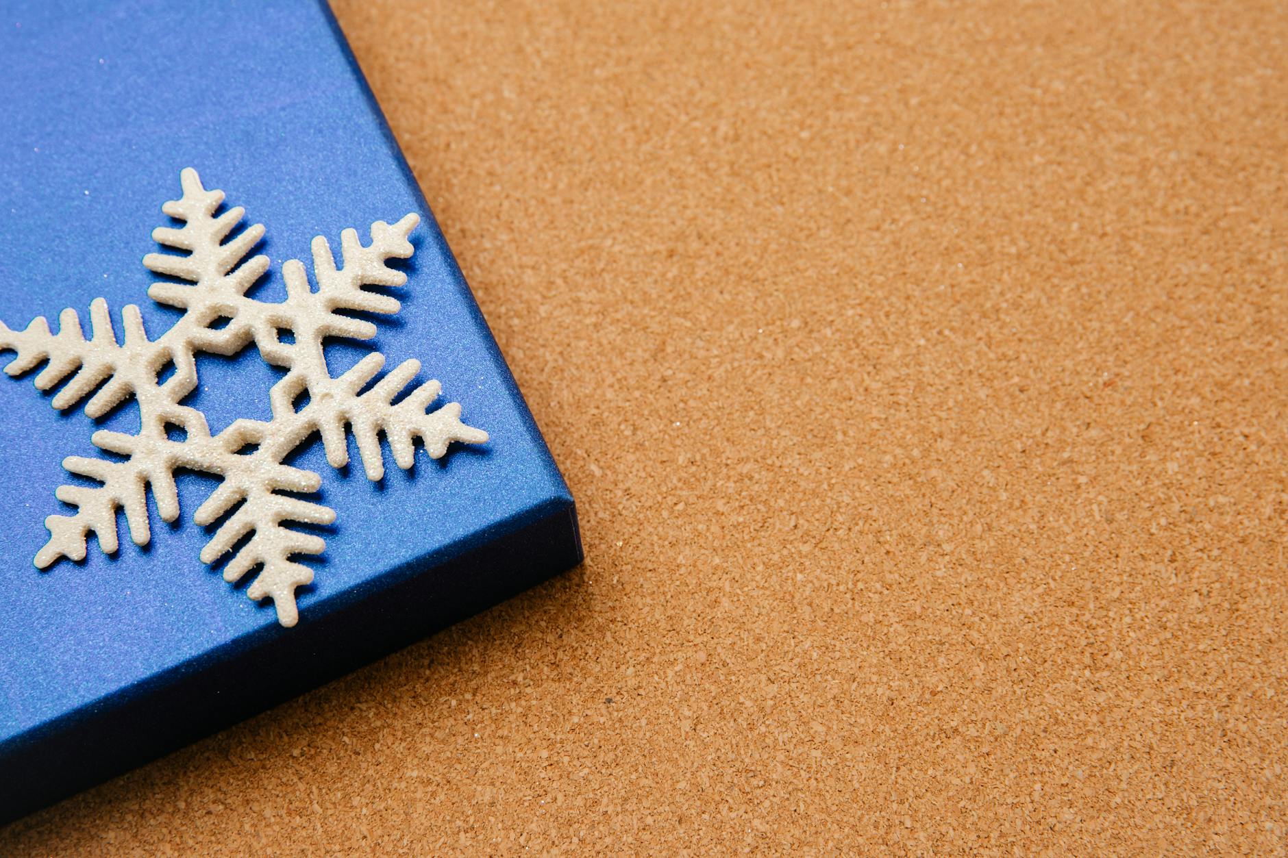 Blue box with Christmas present and white snowflake