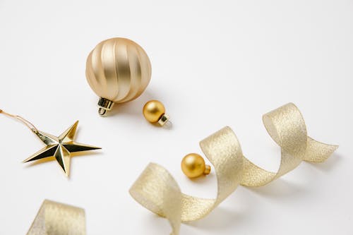 Christmas composition of golden ribbon and hanging decorations