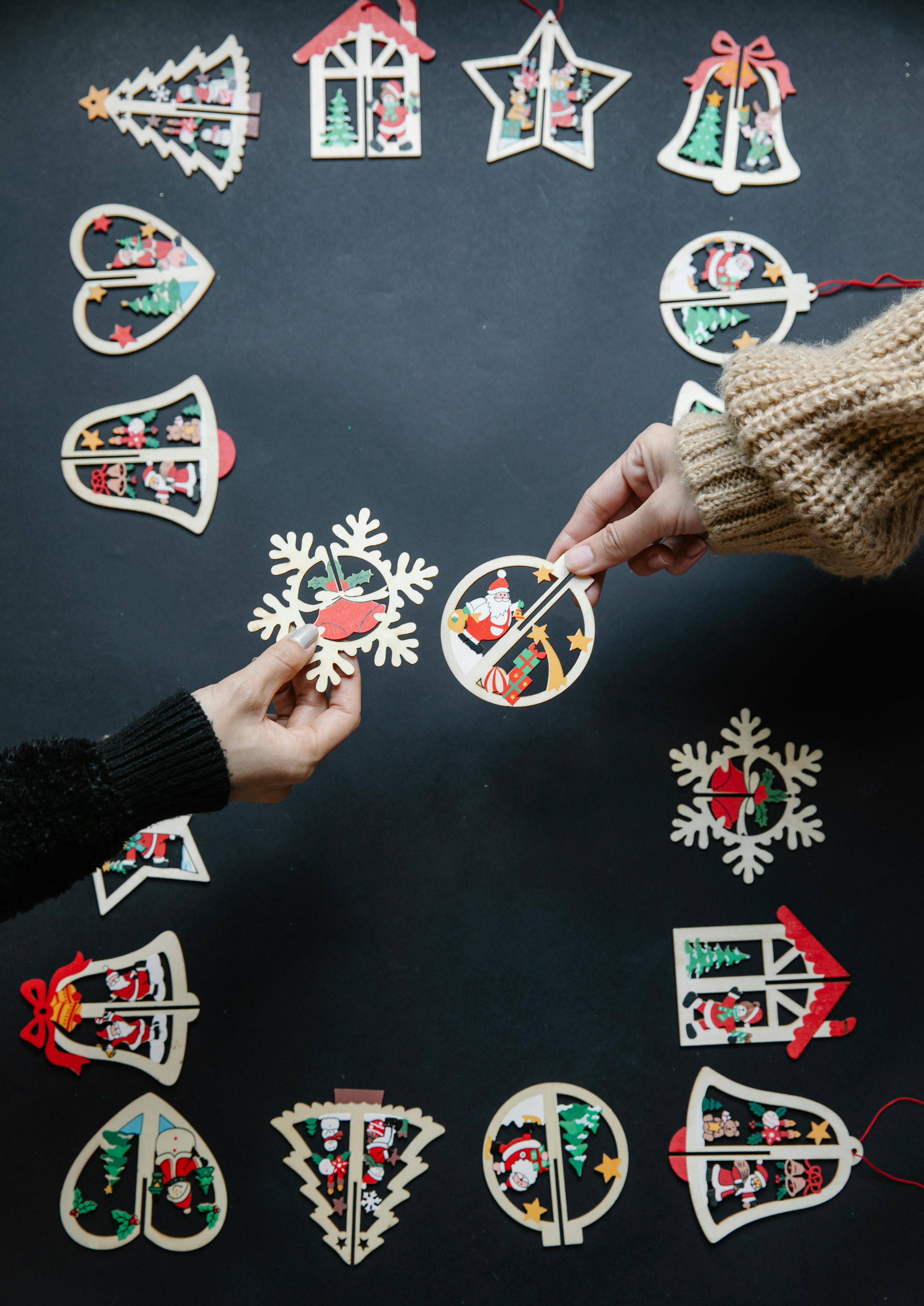 people with colourful paper christmas decorations