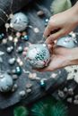 Anonymous person near Christmas decorations with balls