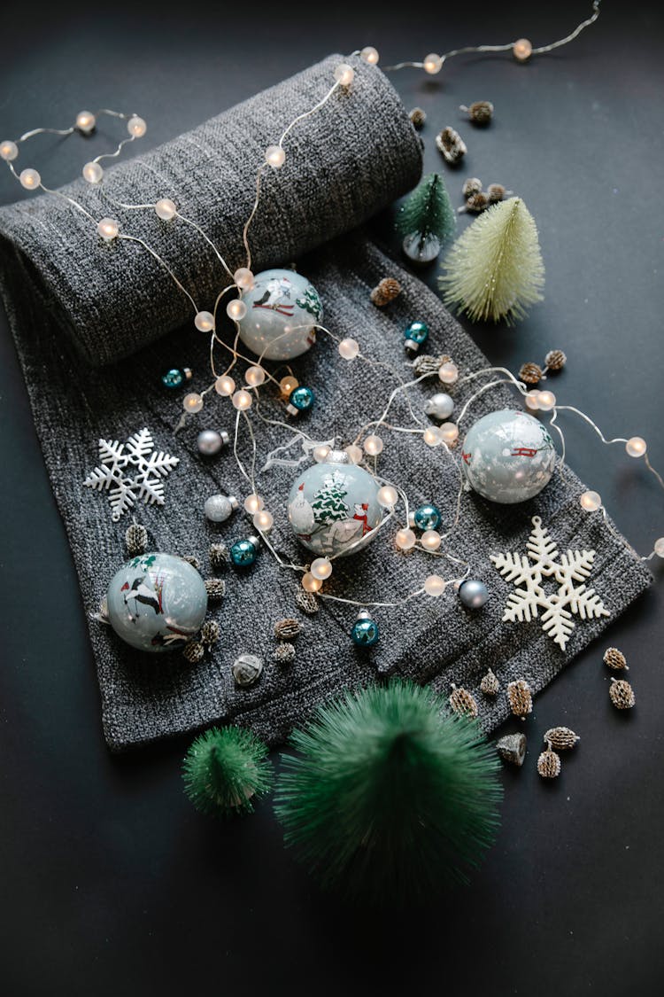 Christmas Garlands Near Balls And Decorative Elements On Gray Textile