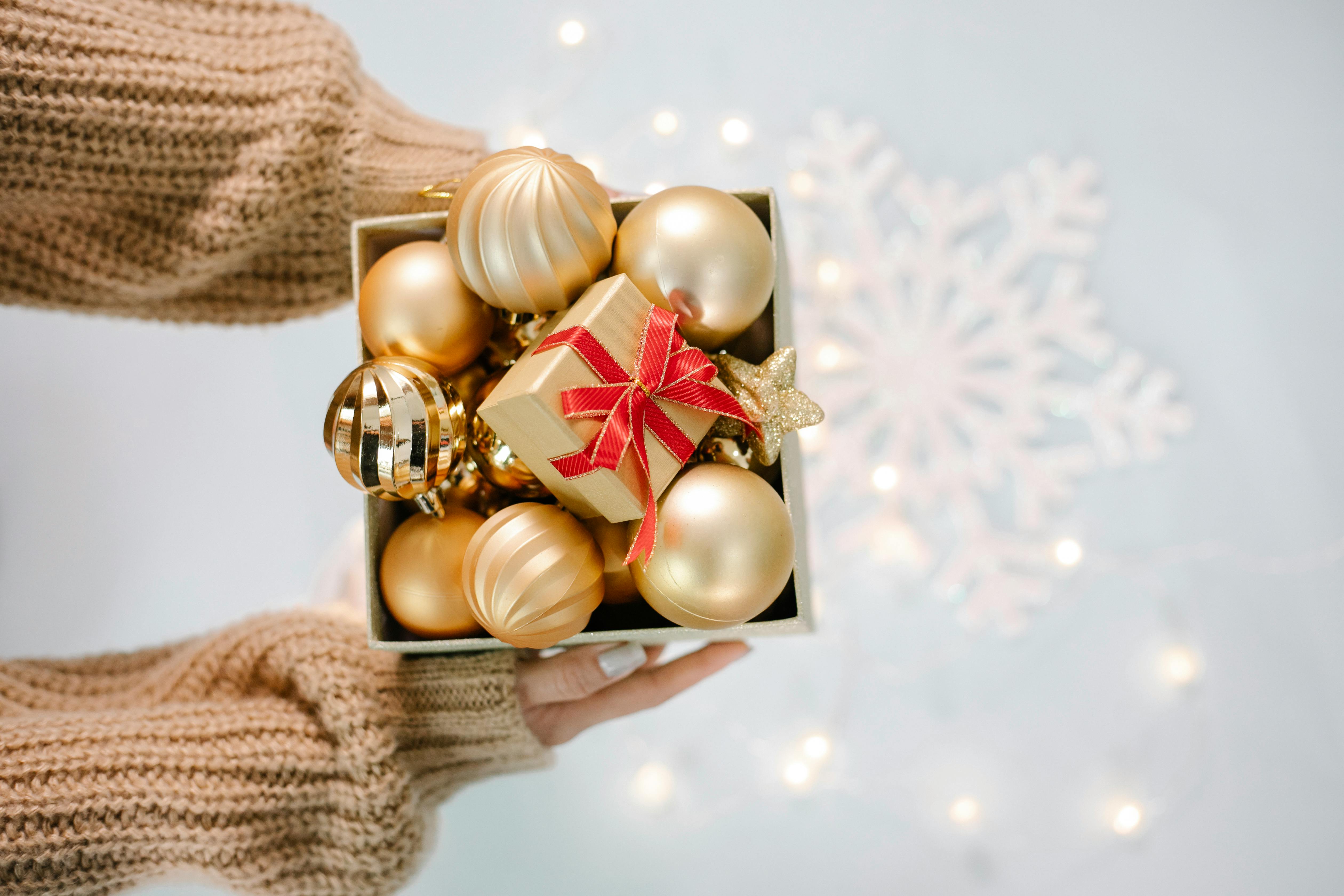 woman showing box with christmas balls