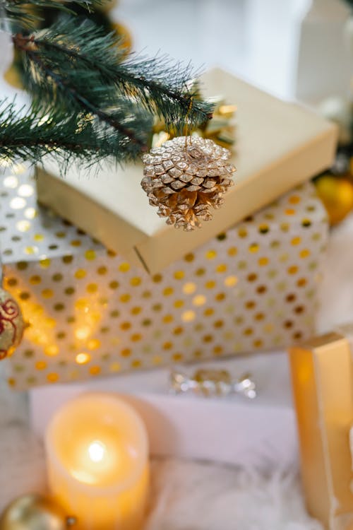 Gifts and candles under Christmas tree