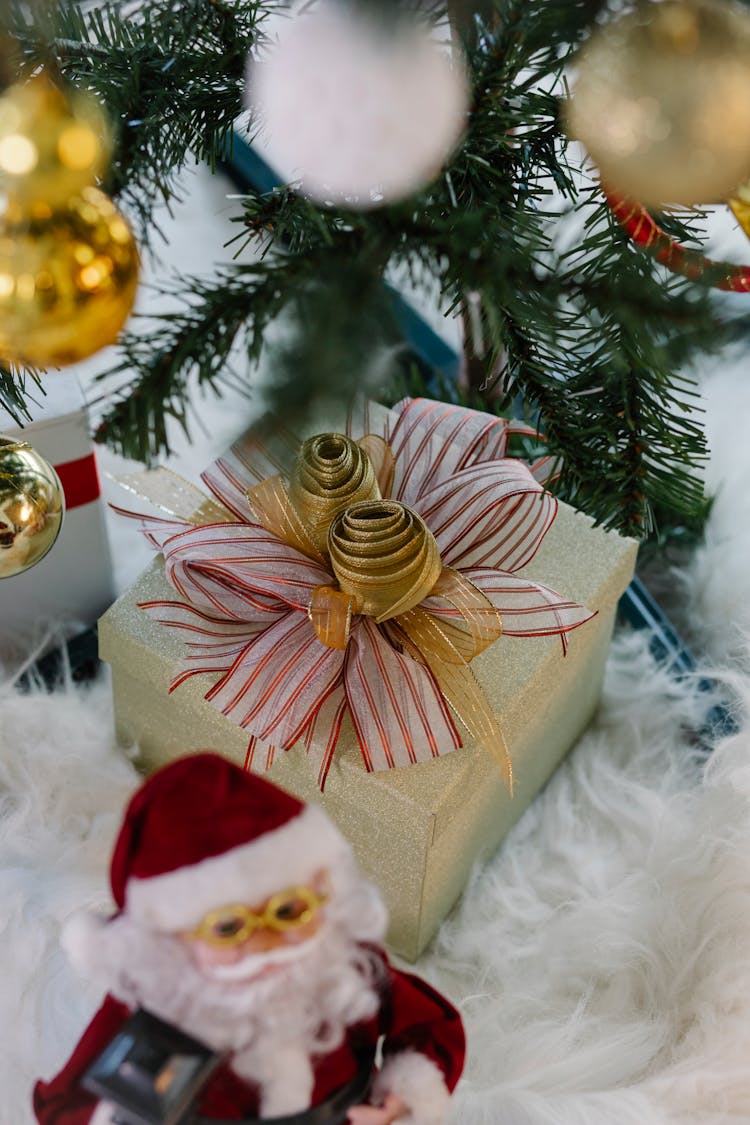 Gift Box And Santa Claus Toy Under Christmas Tree