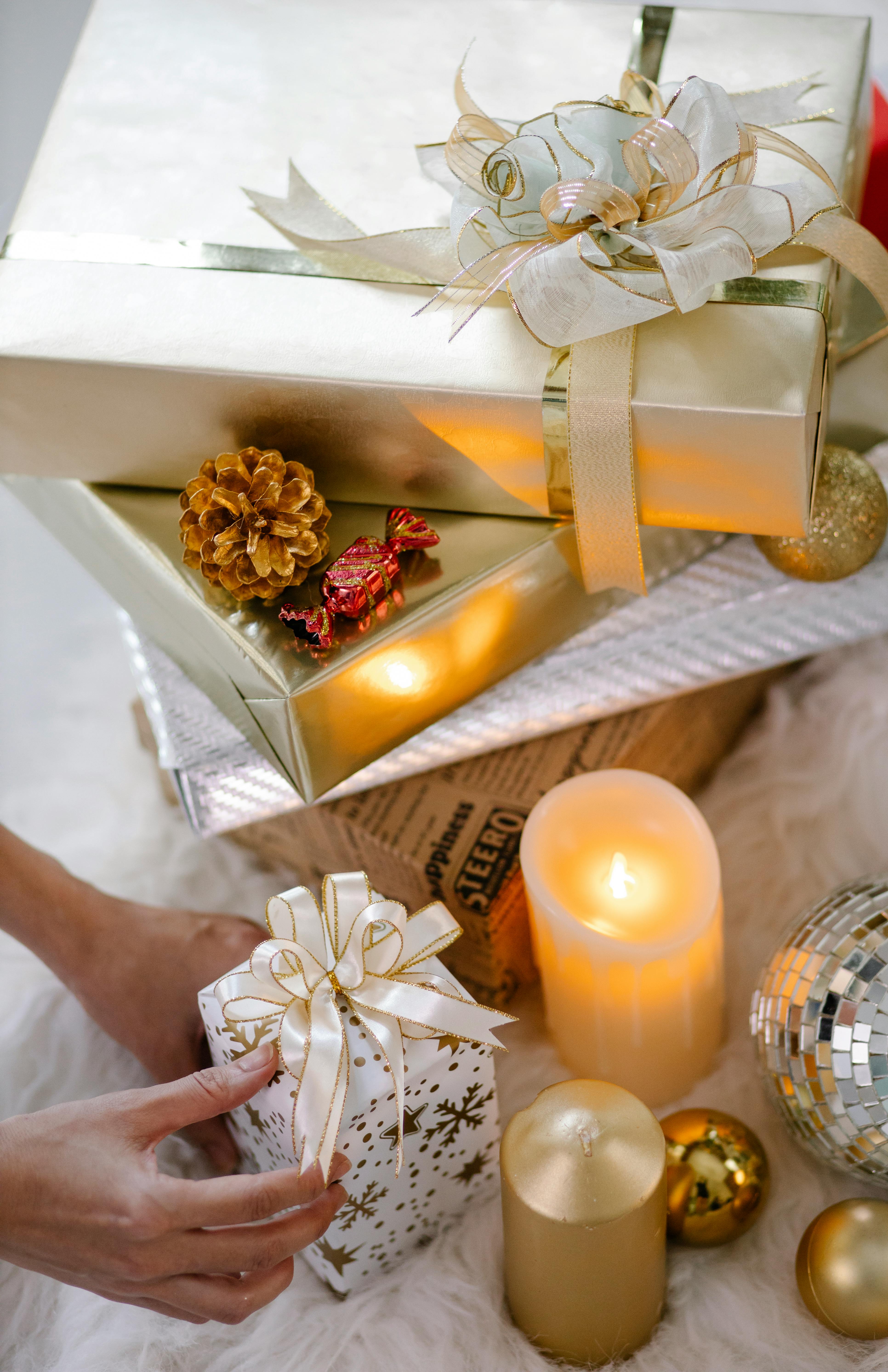 crop person with christmas gift box and decorations