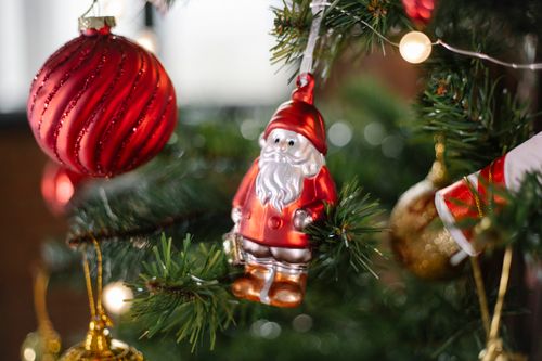 Free Various bright toys and decorations with fairy lights hanging on branches of coniferous Christmas tree Stock Photo