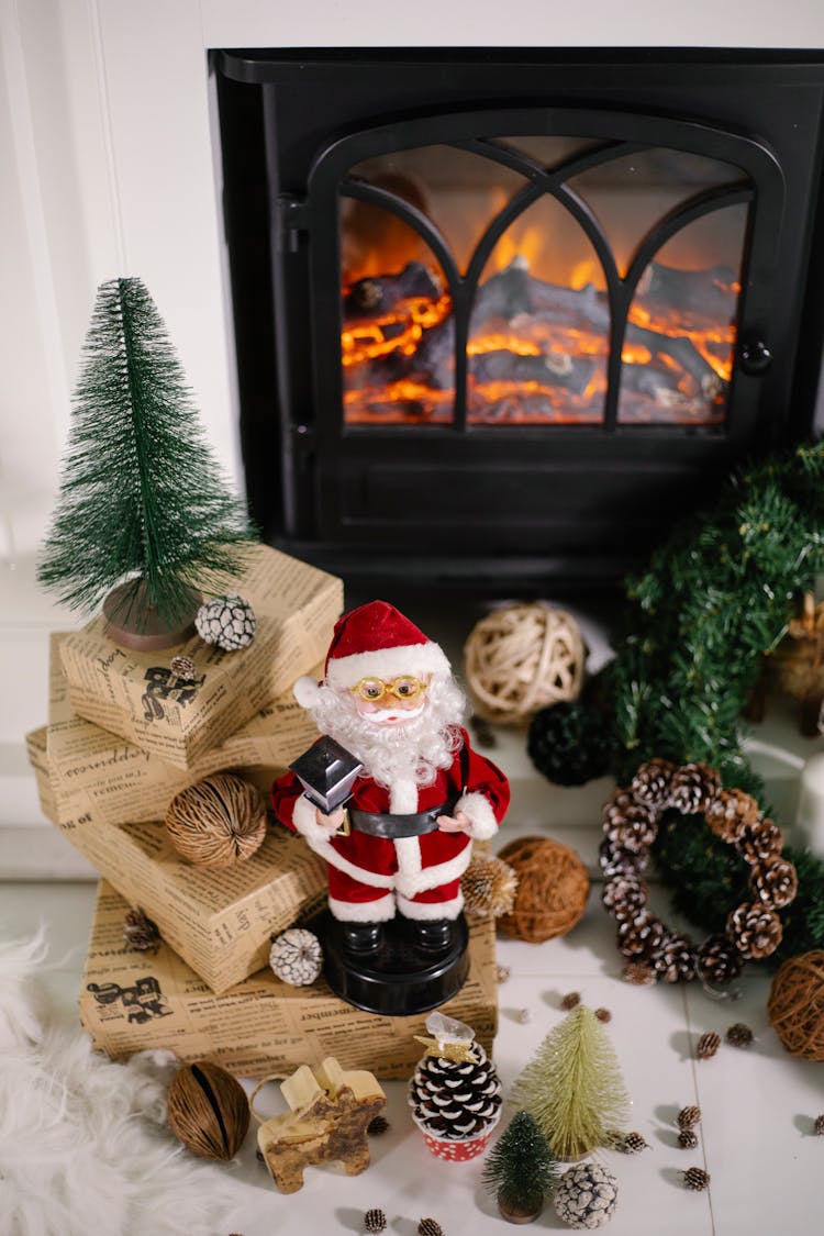 Christmas Presents And Toys On Floor Near Fireplace