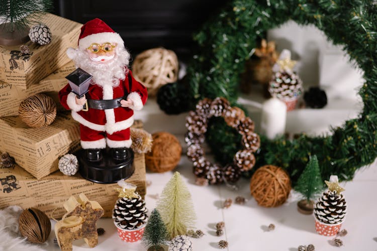 Santa Claus Toy And Wreath On Floor