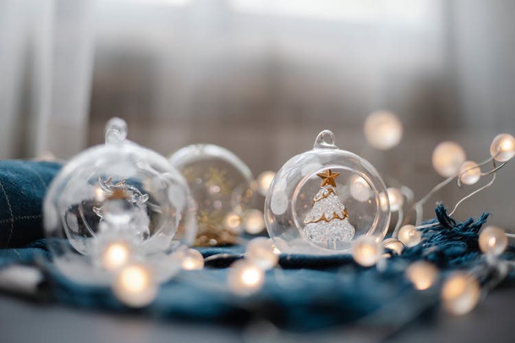 Glass Balls With Fairy Lights On Blue Cloth