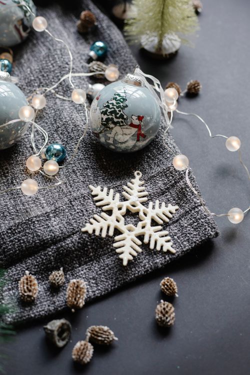 Free From above of various decorations consisting of shiny garland balls with fir cones placed near star for Christmas preparation Stock Photo