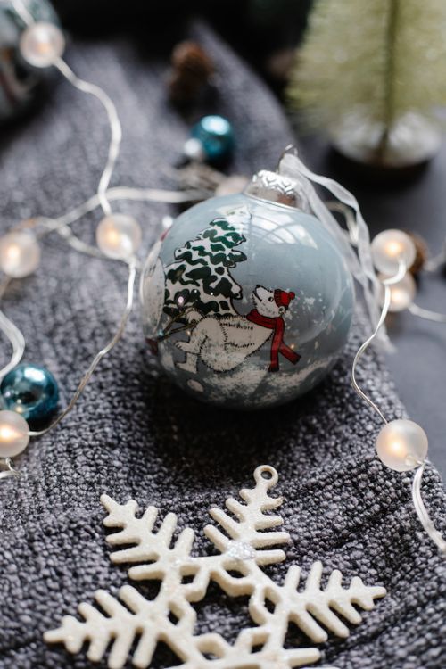 Free High angle of decorative Christmas ball placed with shiny garland near star shaped toy on plaid Stock Photo