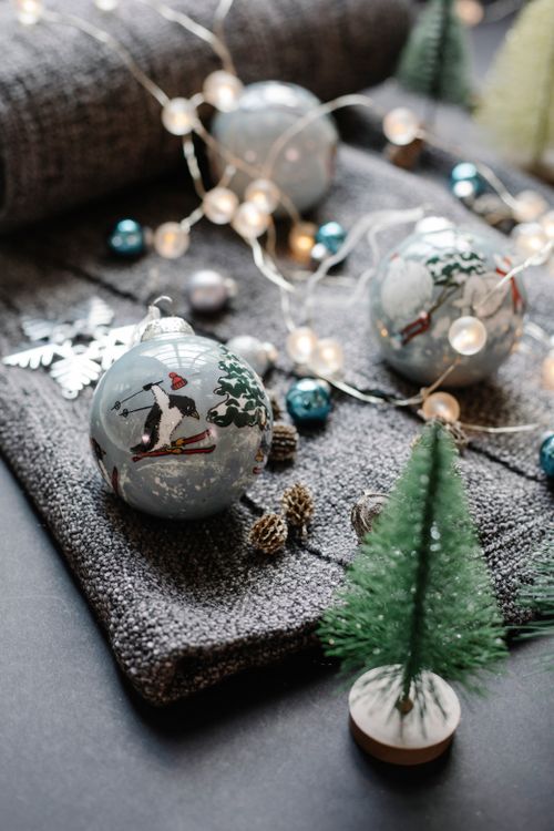 Free High angle of glass balls arranged with fir cones and star placed near decorative spruce Stock Photo