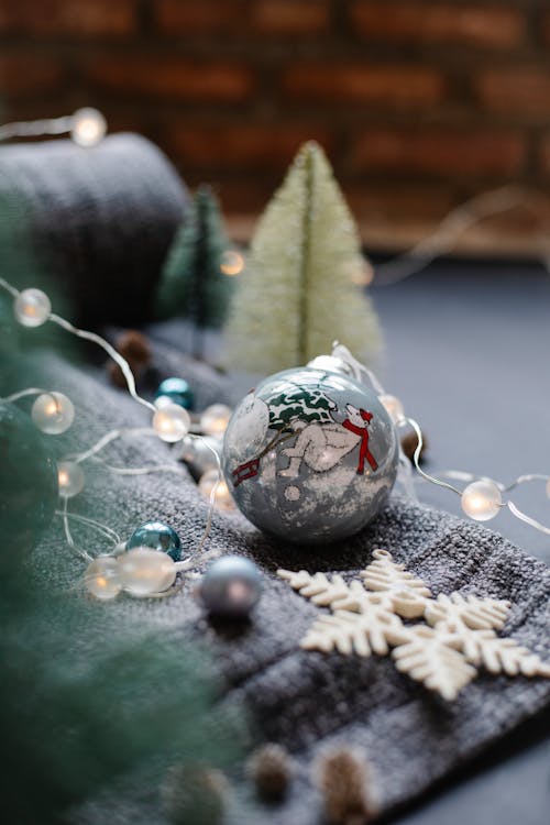 Christmas decorations on plaid near fir tree