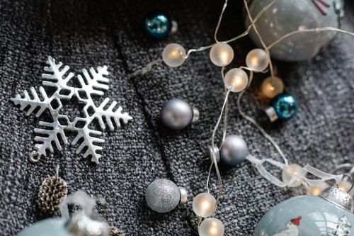 Free From above of decorative baubles with shiny garland with star near fir cone Stock Photo