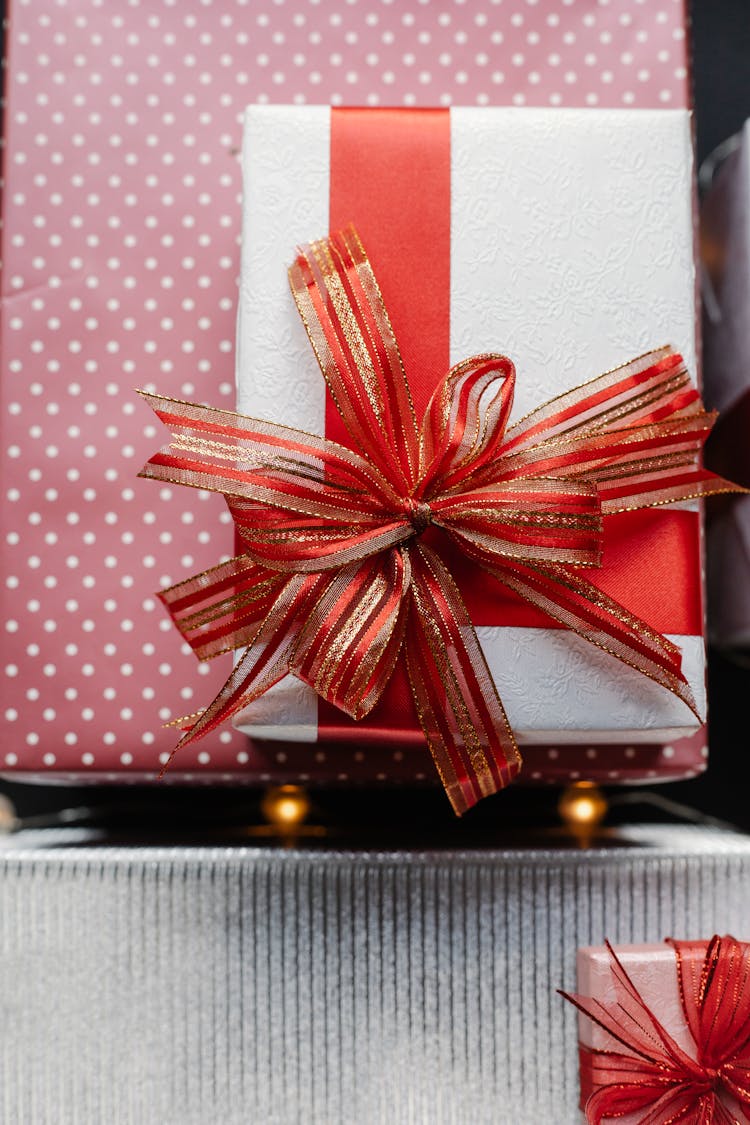 Present Box With Red Ribbon On Wrapped Gifts