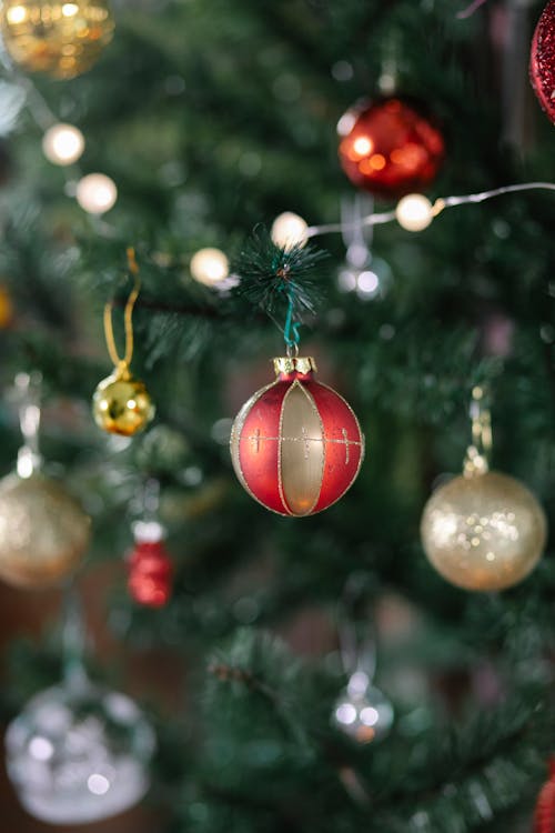 Fir tree with balls and garland during Christmas celebration
