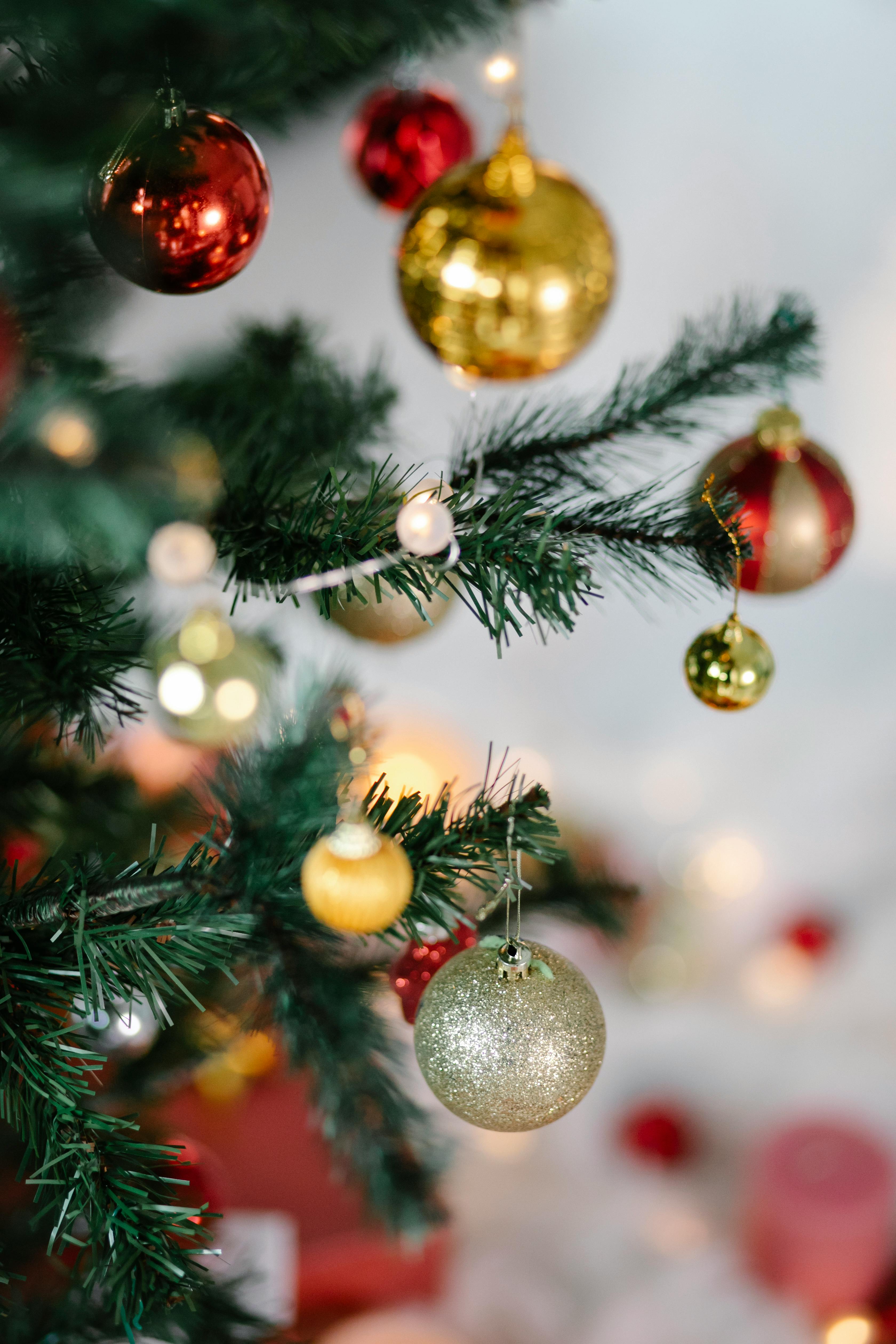 christmas tree with red and golden baubles and glowing lights