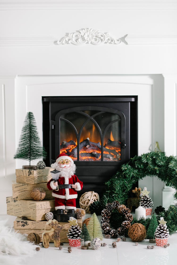 Burning Fireplace With Christmas Decoration In Cozy House