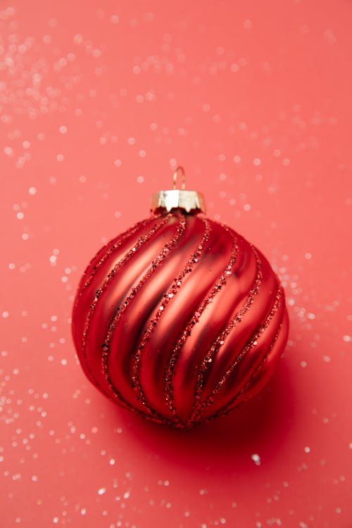 Christmas bauble placed on shiny surface