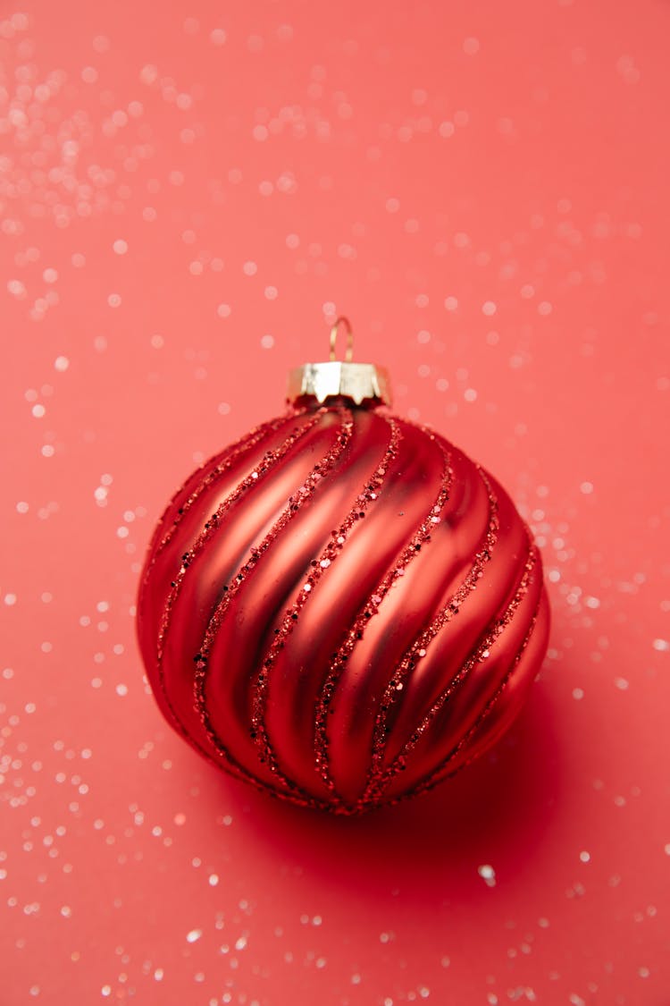 Christmas Bauble Placed On Shiny Surface