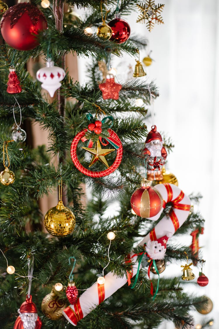 Gold And Red Baubles On Green Christmas Tree