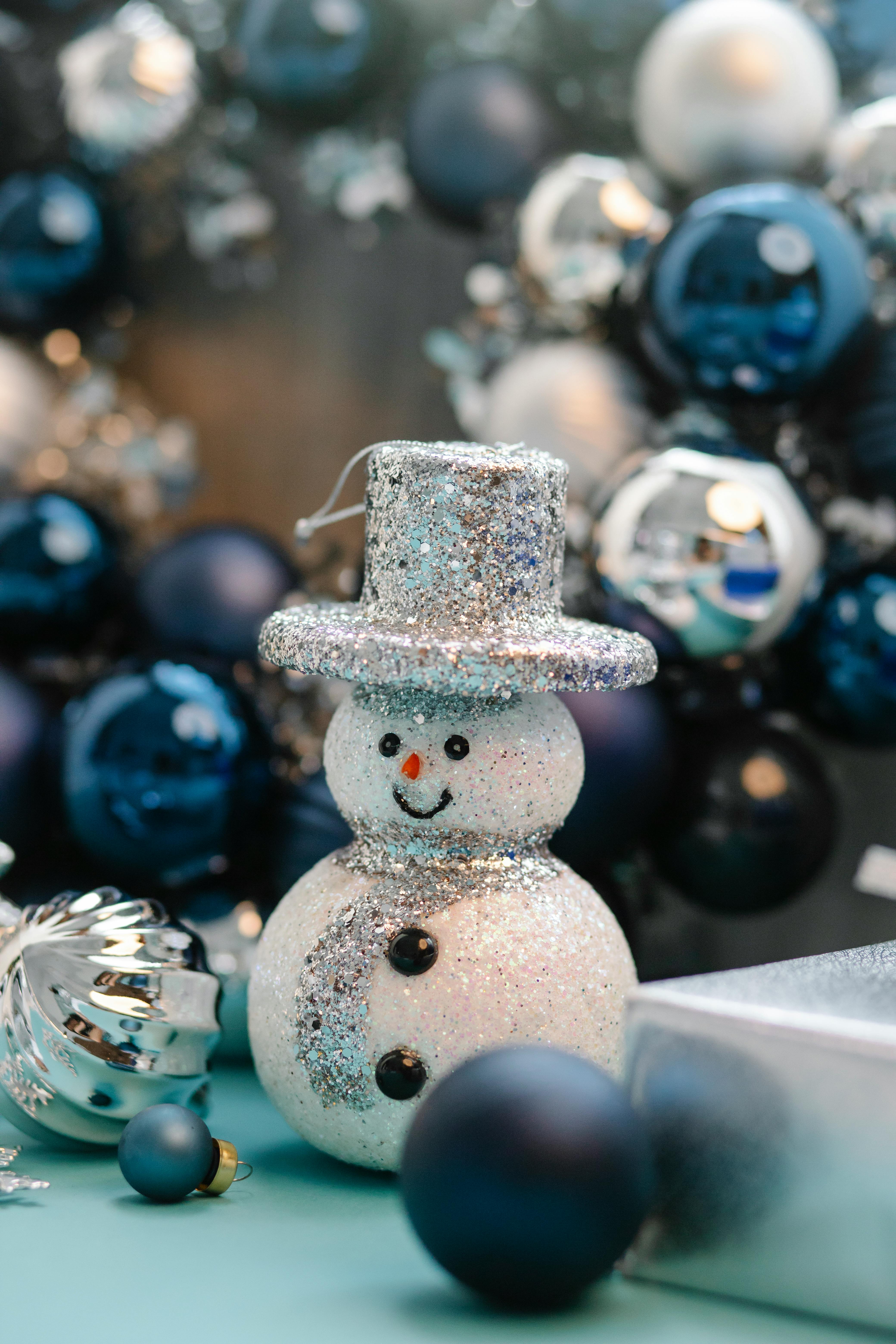 decorative snowman between baubles on christmas day