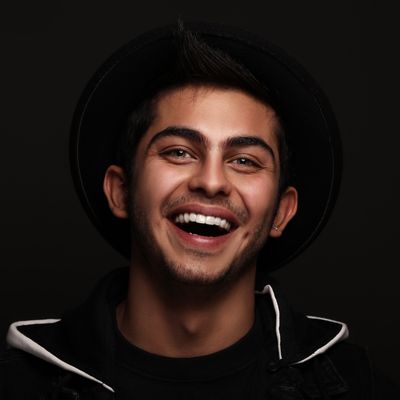 Young man smiling broadly — photo by Amir SeilSepour on Pexels