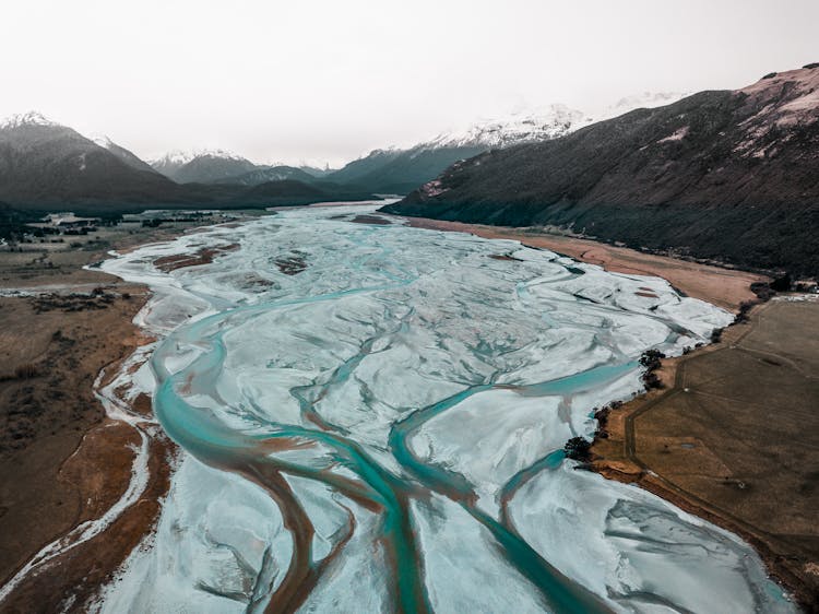 Rivers And Snowcapped Mountains