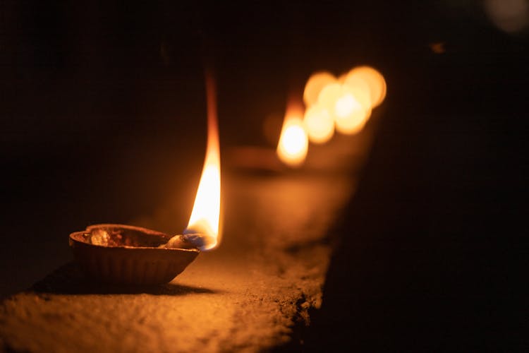 
A Close-Up Shot Of A Lighted Diya