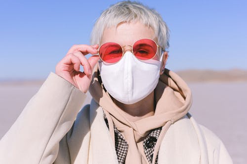 Woman in Beige Hoodie Jacket Wearing Red Sunglasses