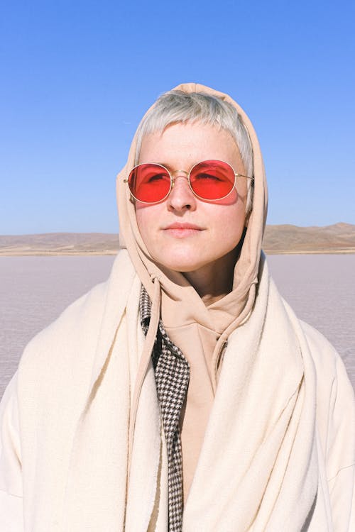 Portrait of a Woman with Sunglasses Wearing a Beige Hoodie