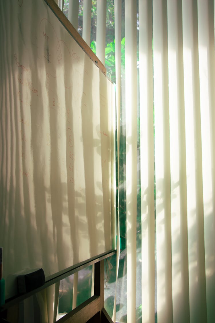 White Board And Eraser Beside Blinds Curtain Window