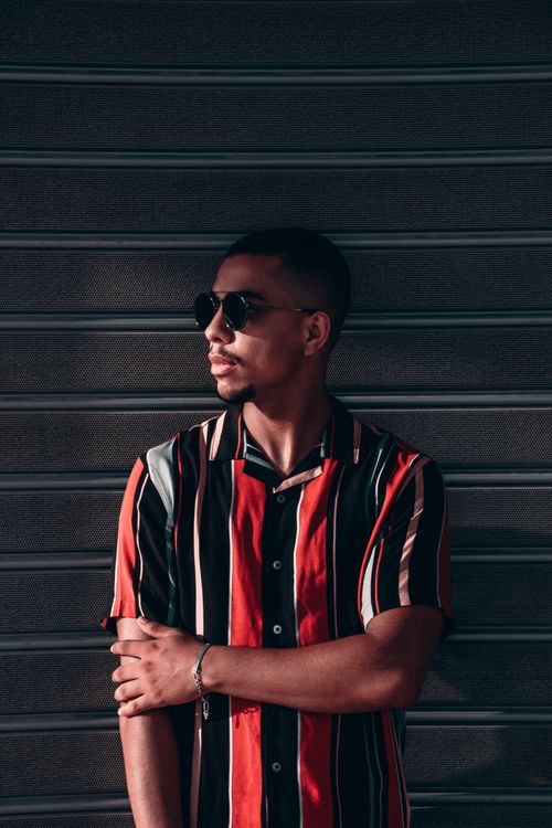Free Fashionable young man posing against striped background in Rabat. Stock Photo