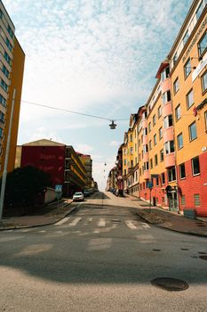 A vibrant street lined with colorful buildings under a bright sky, perfect for city living themes.